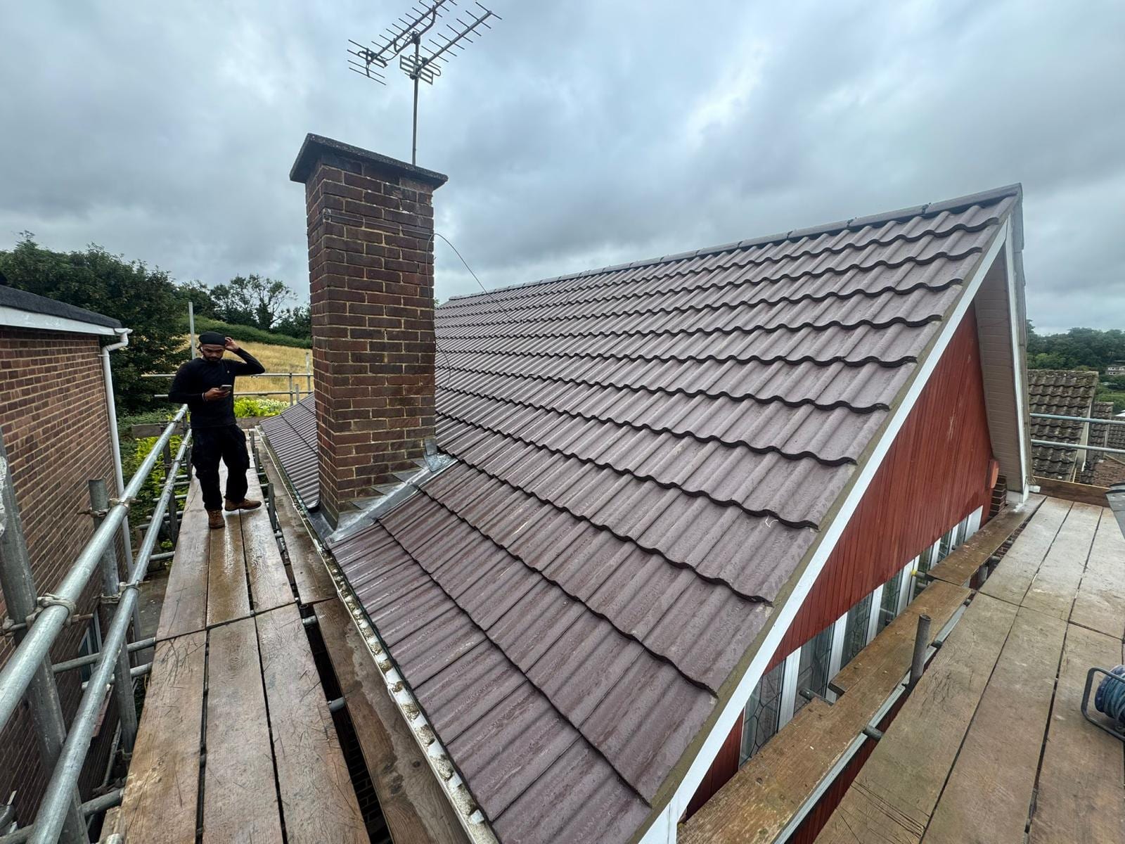 Active Roofing roofer on a completed roof in Hertfordshire